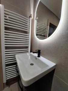 a bathroom with a white sink and a mirror at Kuća za odmor "Mira" in Foča +79 photos