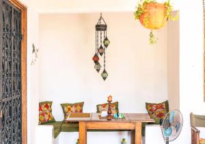 a room with a table with a laptop on it at Dragonfly Cottage - Courtyard Garden 3 Bedrooms in Bagamoyo