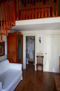 a living room with a white couch and a chair at GOLA Dimora storica in Cerignola