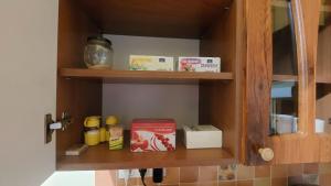 a kitchen cabinet with some food items on it at Piac Kuckó Apartman in Debrecen +6 photos
