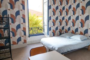 a small room with a bed and a window at Alpazur in Nice