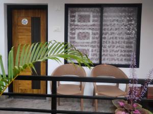a group of chairs and a table with a plant at Om Coast Gokarna in Gokarna