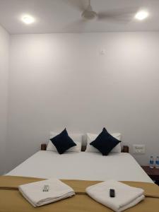 a bedroom with a bed with two towels on it at Om Coast Gokarna in Gokarna