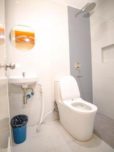 a bathroom with a toilet and a sink at Astrotel Monumento in Manila +68 photos