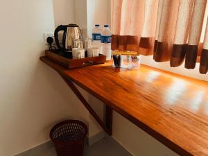 a wooden counter top with a coffee maker on it at Diyon'S Lodge in Ella