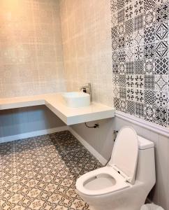 a bathroom with a toilet and a sink at Koh Kood BED's in Ko Kood