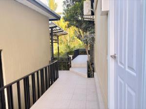 a hallway leading to a house with a door at Koh Kood BED's in Ko Kood