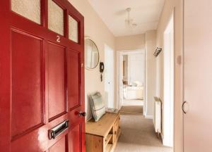 a red door in a room with a bedroom at Mabels View in Melrose