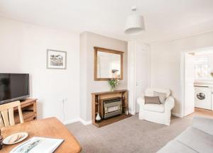 a living room with a television and a chair at Mabels View in Melrose