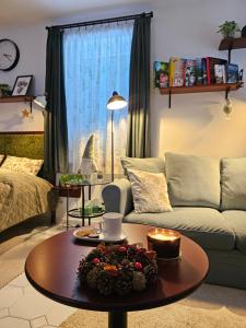 a living room with a couch and a coffee table at Zöld Vendégház - Siklós in Siklós