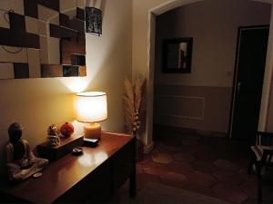 a room with a table with a lamp on it at Bienvenue ! in Moissac