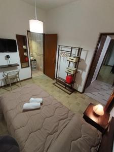a bedroom with a large bed with two towels on it at Pianofilecciarooms in Salemi