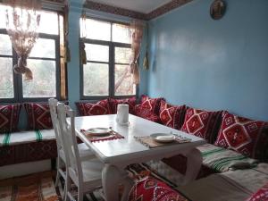 a living room with a table and a couch at Palmas Magramane Ogandou in Skoura +48 photos