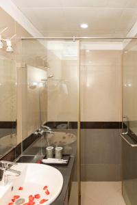 a bathroom with a sink and a shower at Capital CauGiay Hotel in Hanoi +41 photos