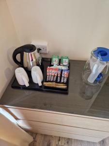 a counter top with a coffee pot and some drinks at Ynyscedwyn Arms in Ystradgynlais