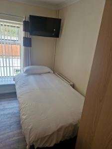 a small bedroom with a bed in a room at Ynyscedwyn Arms in Ystradgynlais