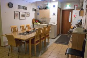 una cucina e una sala da pranzo con tavolo e sedie di Gasthaus Mikkeli a Mikkeli