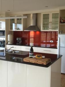 a kitchen with a bottle of wine on a counter at Black Rock Retreat in Howth