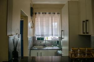 a kitchen with a sink and a window at Dawn's Place in Harare