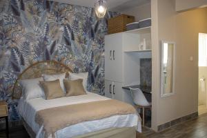 a bedroom with a bed with a blue and white wallpaper at Dawn's Place in Harare