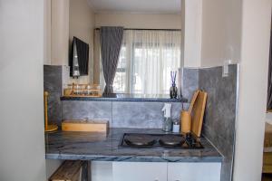 a kitchen with a stove and a counter top at Dawn's Place in Harare