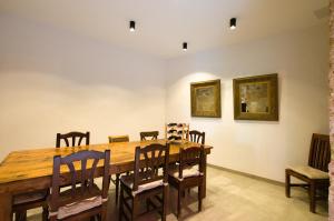 a dining room with a wooden table and chairs at Casa Langlois in Telde