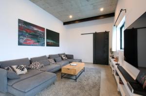 a living room with a couch and a flat screen tv at Casa Langlois in Telde