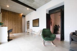 a living room with a green chair and a table at Casa Langlois in Telde +42 photos
