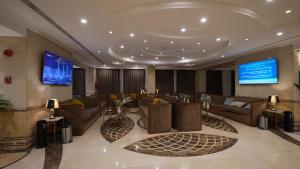 a lobby with couches and a television in a building at ASTONEAST TAIBA Hotel in Medina