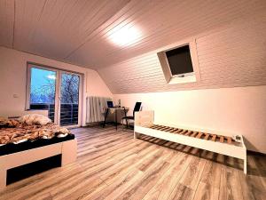 a bedroom with a bed and a desk and a window at Room4U in Memmingen