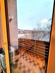 a balcony with a view of a snow covered field at Room4U in Memmingen