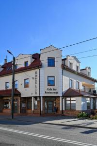 a building on the corner of a street at Apartamenty Cafe Wielbark in Wielbark