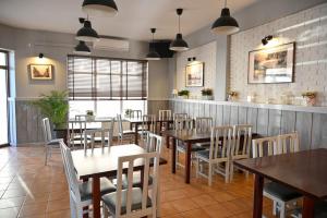 a dining room with wooden tables and chairs at Apartamenty Cafe Wielbark in Wielbark