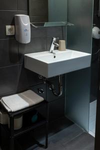 a bathroom with a white sink and a mirror at AMS Rooms in Ljubljana +47 photos