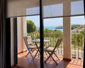 a balcony with a table and two chairs at Olimar, vistas al mar y relax junto a la playa in L'Ampolla