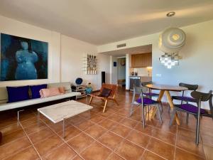 a living room with a table and a couch at Olimar, vistas al mar y relax junto a la playa in L'Ampolla +34 photos