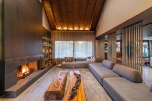 a living room with a couch and a fireplace at Chateau Laghetto Collection Oficial in Gramado