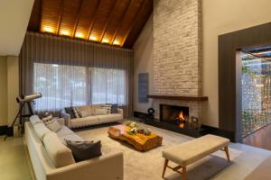 a living room with a couch and a fireplace at Chateau Laghetto Collection Oficial in Gramado +80 photos