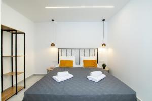 a bedroom with a large bed with two white chairs at The Olive Grove Cottage by Konnect - 2,5km from Ipsos in Ipsos