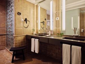 a bathroom with two sinks and a large mirror at Hotel Único Madrid, Small Luxury Hotels in Madrid +66 photos