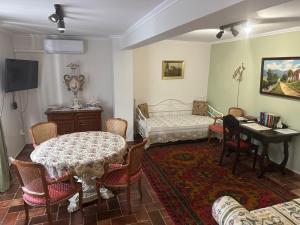 a living room with a table and a piano at Casa Eloria in Békéscsaba