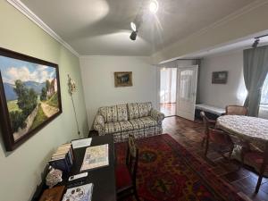 a living room with a couch and a table at Casa Eloria in Békéscsaba