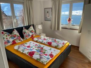 two beds in a room with windows at Wallner am See in St. Wolfgang