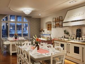 a restaurant with tables and chairs in a kitchen at Amadria Park Hotel Agava in Opatija