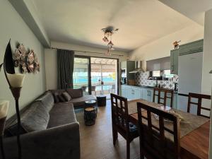 a living room and kitchen with a couch and a table at Pythagorion Harbour Residence in Pythagoreio
