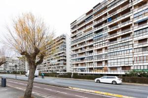 a white car parked in front of a large building at Itsas aurre Basquenjoy in Fuenterrabía