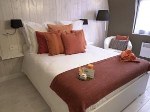 a bedroom with a large white bed with orange pillows at B&B Be In Brussels in Brussels