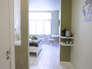 a room with a bedroom with a bed and a window at B&B Be In Brussels in Brussels +13 photos