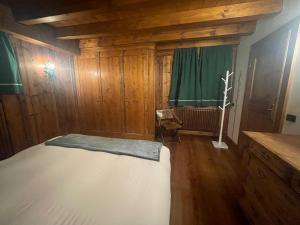 a room with a bed and a green curtain at Chalet Alba in Cortina dʼAmpezzo