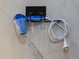 a wall with a hair dryer and a cord on a wall at Kuhama Private Mountain Chalet Naggar in Nagar